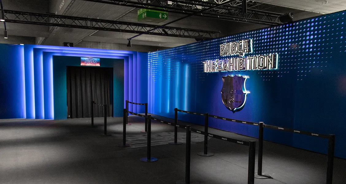 Blue-lit exhibition lobby and signage